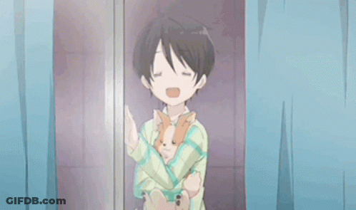 A Young Boy Is Holding A Small Dog In His Arms . GIF