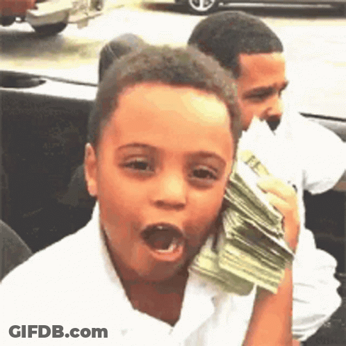 A Young Boy Is Holding A Stack Of Money In His Hand And Making A Funny Face . GIF