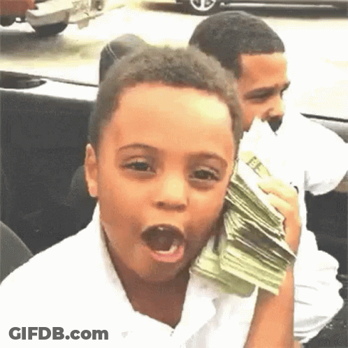 A Young Boy Is Holding A Stack Of Money In His Hand And Making A Funny Face . GIF