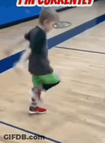 A Young Boy Is Kicking A Ball On A Basketball Court And The Caption Says I 'M Currently . GIF