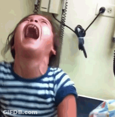 A Young Boy Is Laughing With His Mouth Open In A Striped Shirt . GIF