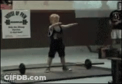 A Young Boy Is Lifting A Barbell In Front Of A Sign That Says House Of Fun GIF