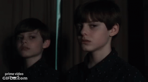 A Young Boy Is Looking At His Reflection In A Mirror With The Words Prime Video Below Him GIF