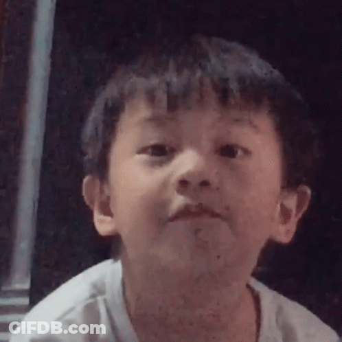 A Young Boy Is Making A Funny Face In A Close Up Of His Face . GIF