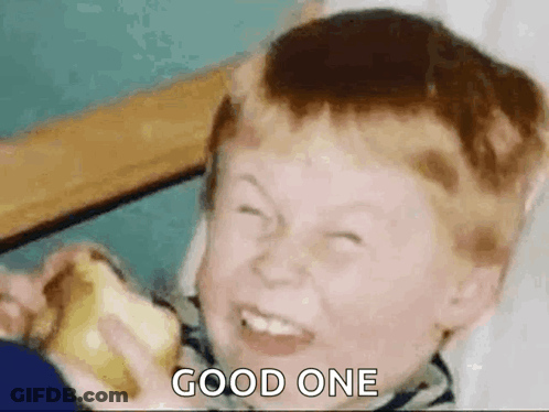A Young Boy Is Making A Funny Face While Eating An Apple . GIF