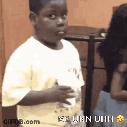 A Young Boy Is Making A Funny Face While Holding A Cup Of Coffee In His Hand . GIF