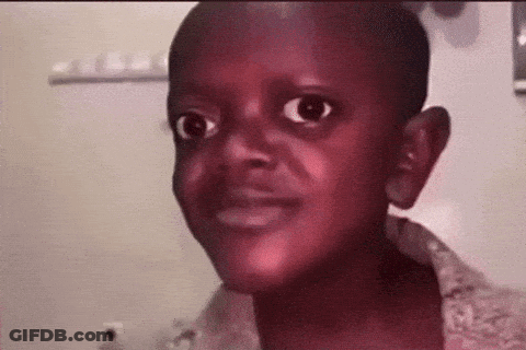 A Young Boy Is Making A Funny Face While Looking At The Camera In A Bathroom . GIF