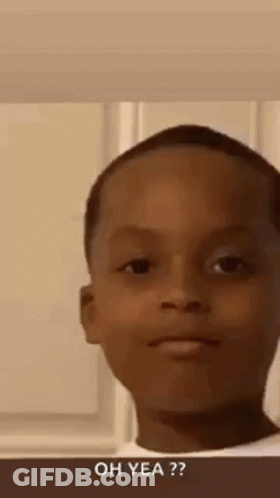 A Young Boy Is Making A Funny Face While Standing In Front Of A Window . GIF