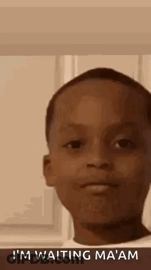 A Young Boy Is Making A Funny Face While Waiting For Something . GIF