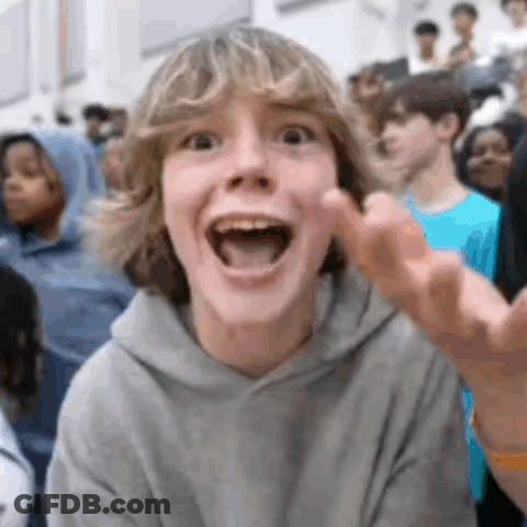 Boy Making Funny Face In Crowd GIF