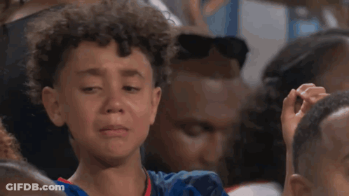 A Young Boy Is Making A Heart Shape With His Hands GIF