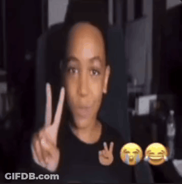 A Young Boy Is Making A Peace Sign In Front Of A Screen With Emojis . GIF