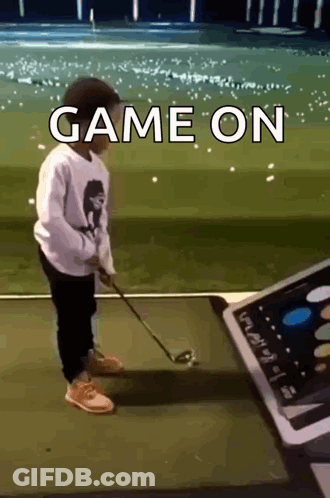 A Young Boy Is Playing Golf With The Words Game On Written Above Him GIF