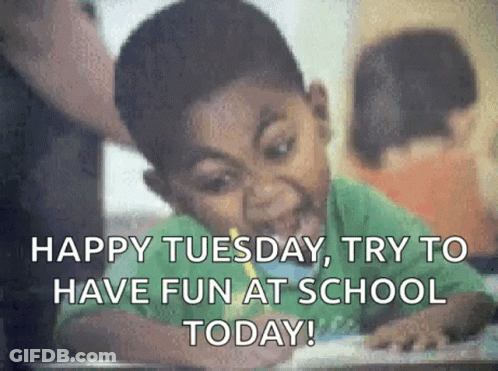 A Young Boy Is Sitting At A Desk In A Classroom . GIF