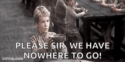 A Young Boy Is Sitting At A Table Holding A Pot Of Soup And A Spoon . GIF