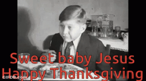 A Young Boy Is Sitting At A Table With A Plate Of Food And The Words Sweet Baby Jesus Happy Thanksgiving GIF