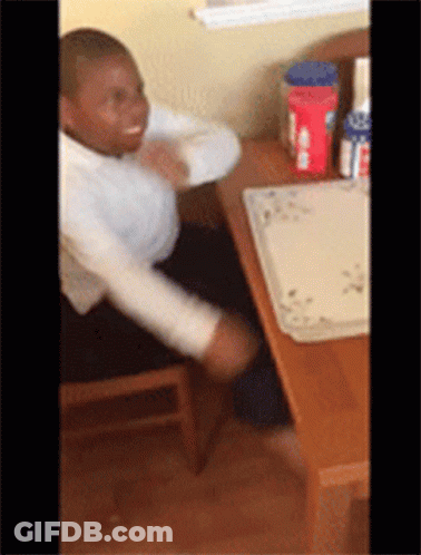 A Young Boy Is Sitting At A Table With A Tray On It That Says ' Oats ' On It GIF