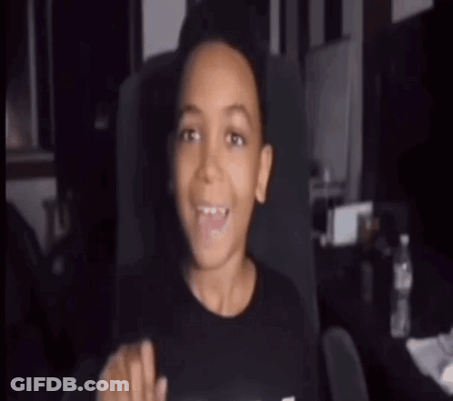 A Young Boy Is Sitting In A Chair With His Mouth Open And A Bottle Of Water In The Background . GIF