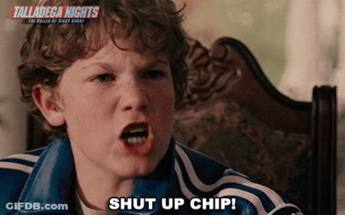 A Young Boy Is Sitting In A Chair With The Words Talladega Nights Behind Him GIF