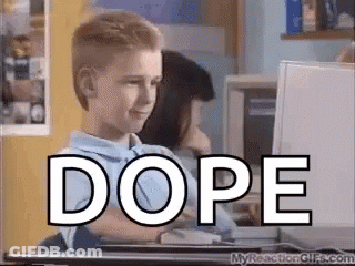 A Young Boy Is Sitting In Front Of A Computer With The Word Dope Written On It . GIF
