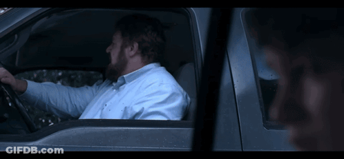 A Young Boy Is Sitting In The Back Seat Of A Red Car GIF