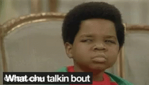 Boy Sitting On Bed Making Funny Face Saying What Chu Talkin Bout GIF