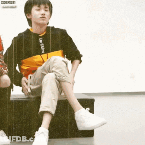 Boy Sitting Cross-Legged On Bench GIF