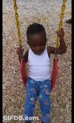 Boy Sitting On Swing In Playground GIF