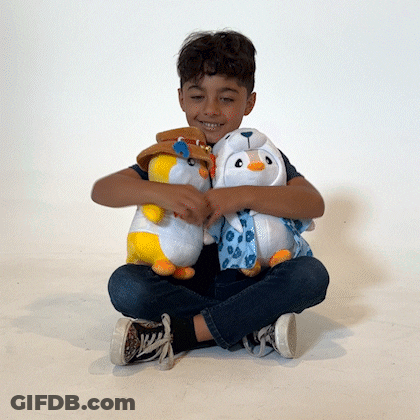 A Young Boy Is Sitting On The Floor With Two Stuffed Animals GIF