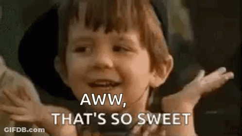 A Young Boy Is Smiling And Saying `` Aww , That 'S So Sweet '' With His Hands Outstretched . GIF