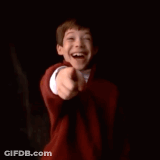 A Young Boy Is Smiling While Holding A Can Of Soda . GIF