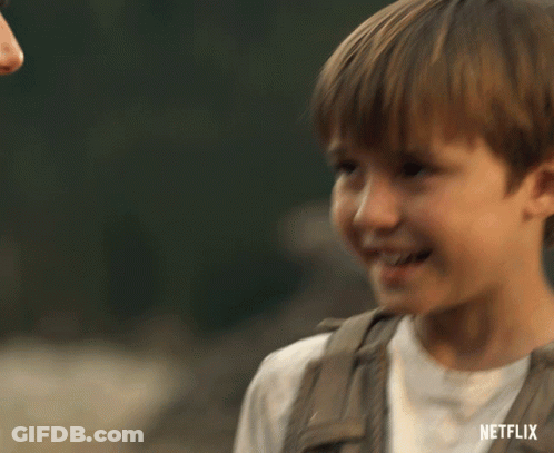 A Young Boy Is Smiling With A Netflix Logo In The Corner GIF