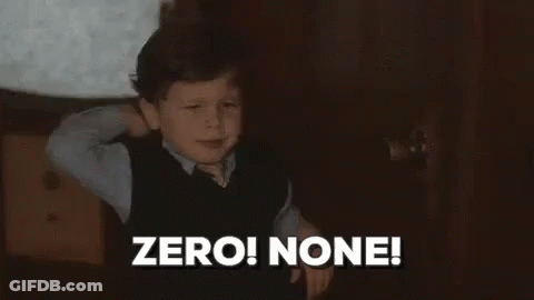 A Young Boy Is Standing In A Dark Room With His Hands Behind His Head . GIF