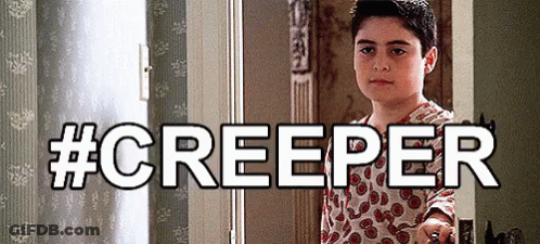 A Young Boy Is Standing In A Doorway With The Words #Creeper Behind Him GIF