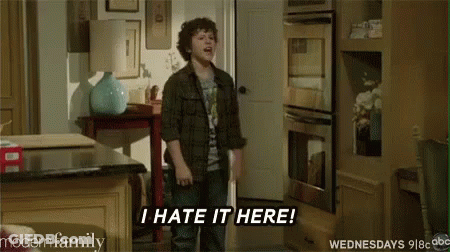 A Young Boy Is Standing In A Kitchen And Says `` I Hate It Here '' . GIF