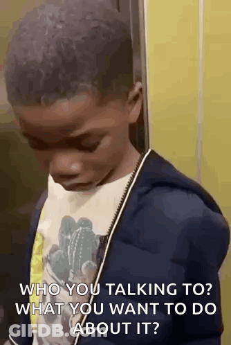 A Young Boy Is Standing In An Elevator Talking To Someone . GIF