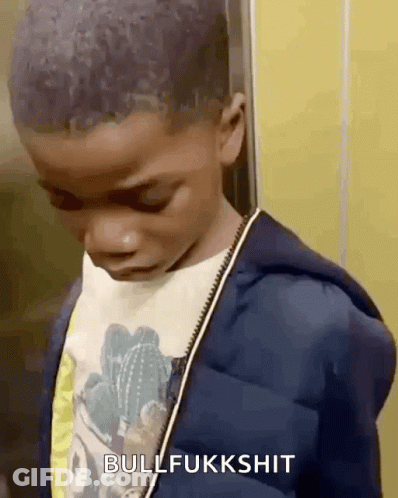 A Young Boy Is Standing In An Elevator With His Eyes Closed And The Words Bullfukkshit Above Him . GIF