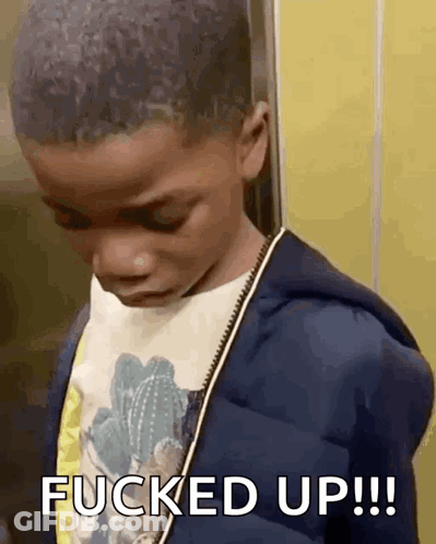 A Young Boy Is Standing In An Elevator With The Words `` Fucked Up '' Written On His Face . GIF