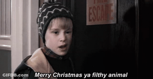 A Young Boy Is Standing In Front Of A Door With A Sign That Says Escape . GIF