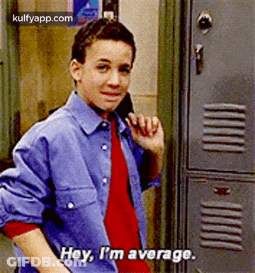 A Young Boy Is Standing In Front Of A Locker And Talking On A Cell Phone . GIF