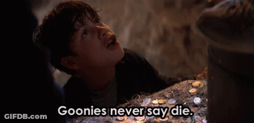 A Young Boy Is Standing In Front Of A Pile Of Coins And Says Goonies Never Say Die . GIF