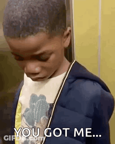 A Young Boy Is Standing Next To A Yellow Wall And Says `` You Got Me '' . GIF