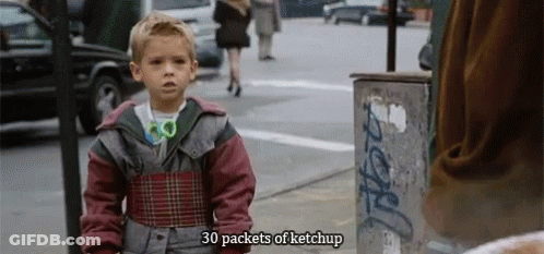 A Young Boy Is Standing On A Street With The Words 30 Packets Of Ketchup Above Him GIF