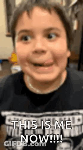 A Young Boy Is Sticking His Tongue Out And Making A Face . GIF