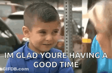 A Young Boy Is Talking To A Woman And Smiling . GIF