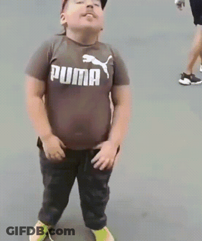A Young Boy Is Wearing A Puma Shirt And Dancing GIF