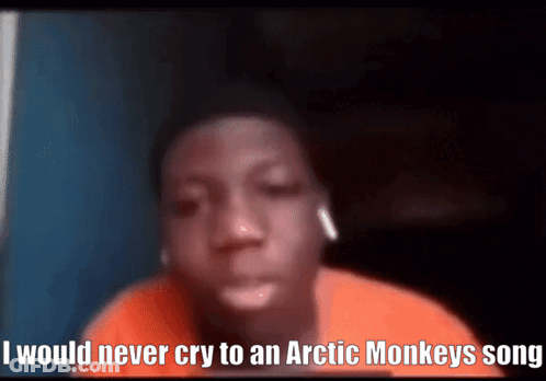 A Young Boy Is Wearing Ear Buds And Says I Would Never Cry To An Arctic Monkeys Song GIF