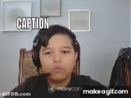 A Young Boy Is Wearing Headphones And Making A Funny Face While Sitting In A Chair . GIF