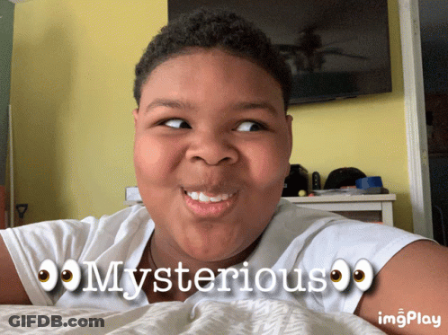 A Young Boy Laying On A Bed With The Words Mysterious On His Shirt GIF