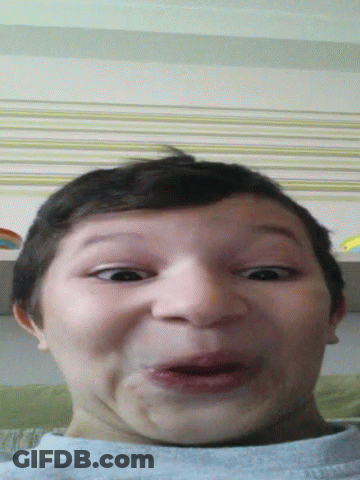 A Young Boy Making A Funny Face With His Mouth Wide Open GIF